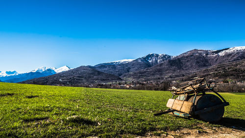 Scenic view of field against blue sky