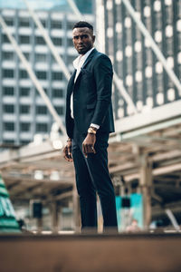 Portrait of success and confident african businessman outdoor posing outdoor in modern city.