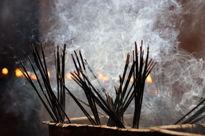 Close-up of smoke emitting from incense sticks