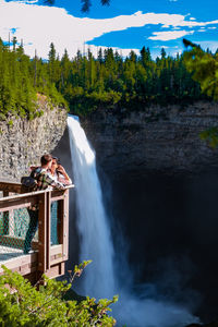 Scenic view of waterfall against trees