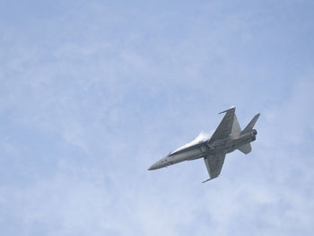 Low angle view of military airplane flying in sky