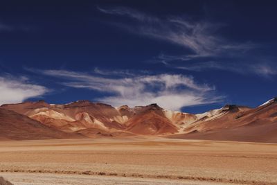 View of desert against cloudy sky