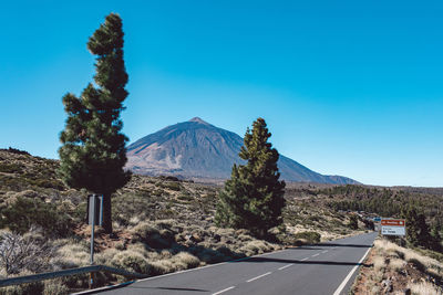 Scenic view of snowcapped mountains against clear blue sky