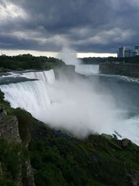 Scenic view of waterfall against sky