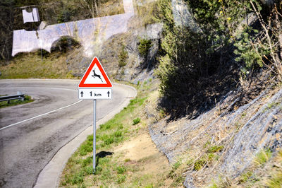 Road sign by mountain