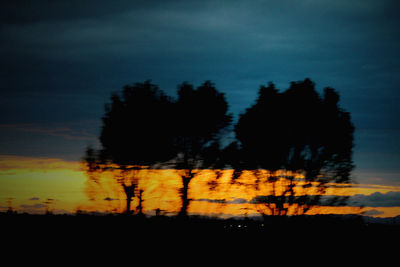 Silhouette trees against sky during sunset