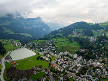 High angle view of townscape and mountains against sky