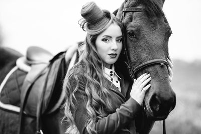 Portrait of young woman with horse