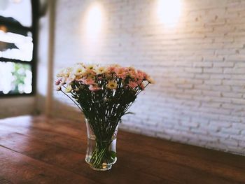 Close-up of flower vase on table at home