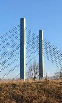 Low angle view of cables against clear blue sky