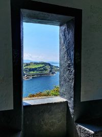 Close-up of sea seen through window