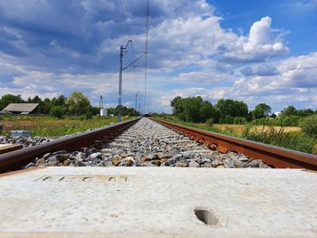 Surface level of railroad tracks against sky