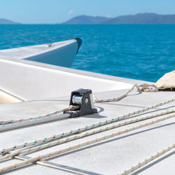 Close-up of railing by sea against sky