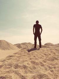 Rear view of man standing in desert