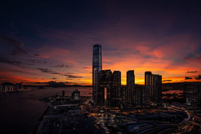 Modern buildings against sky during sunset