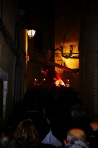 People in illuminated building at night