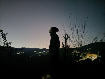 Silhouette man standing against sky during sunset