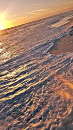 Aerial view of sea against sky during sunset