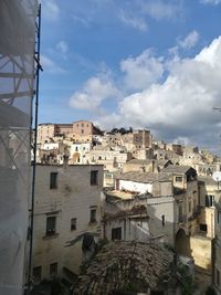 Low angle view of buildings in town against sky