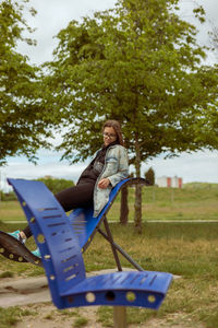 Full length of woman sitting on field