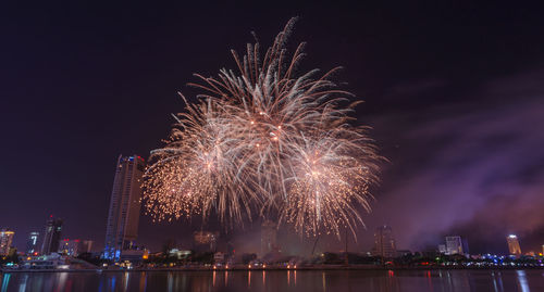 Low angle view of firework display at night