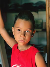 Portrait of serious girl standing at home