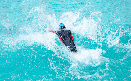 Man surfing in swimming pool