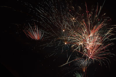 Low angle view of firework display at night