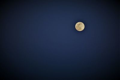 Low angle view of moon against sky at night