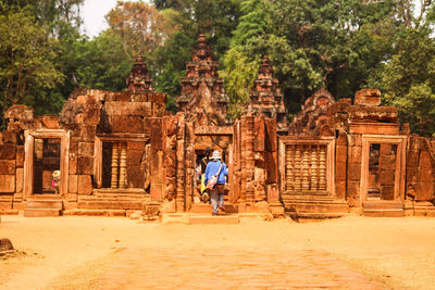 Man walking in banteay srei temple