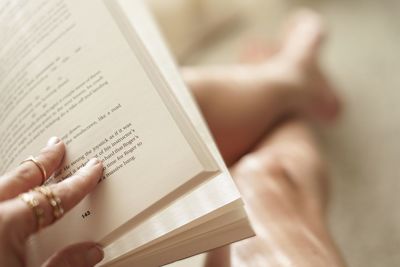 Midsection of woman reading book