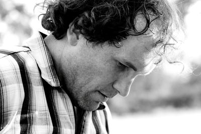 Close-up portrait of man looking away outdoors