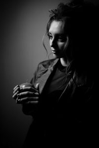 Black and white photo of a girl with an apple