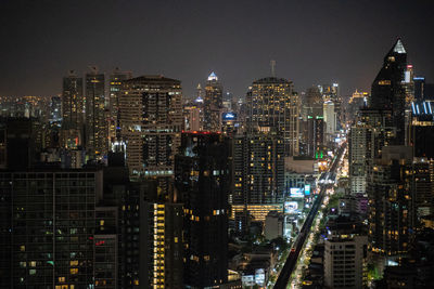 Aerial view of illuminated buildings in city at night