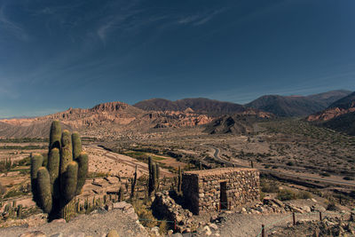 Panoramic view of mountains against blue sky