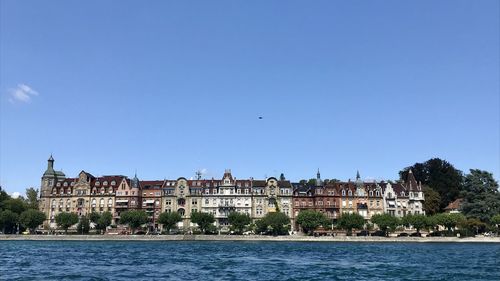 Buildings in city against clear sky