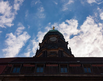 Low angle view of building against cloudy sky