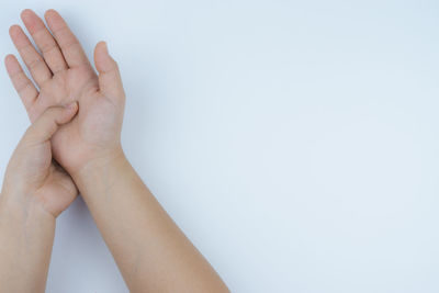 Close-up of woman hand against white background