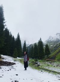 Rear view of man on snow covered land