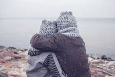 Close-up of person wearing hat on land against sky