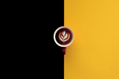 Coffee cup against orange background