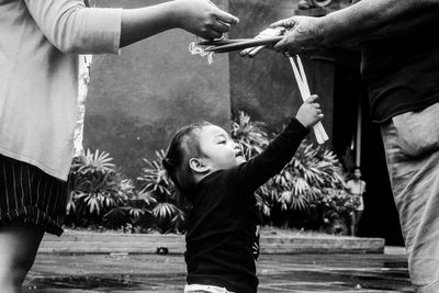 Close-up of hands holding girl