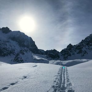 Scenic view of snow covered mountains against sky