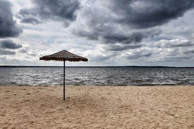 Lifeguard hut on beach against sky