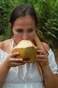 Young woman drinking coconut water