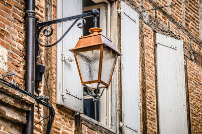 Low angle view of street light against building