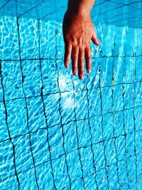 Midsection of person swimming in pool