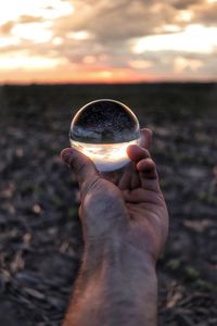 Close-up of hand holding crystal ball