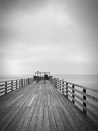 Pier over sea against sky