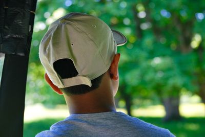 Rear view of boy against trees